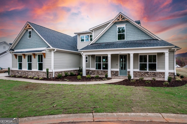 craftsman inspired home featuring a lawn and a porch