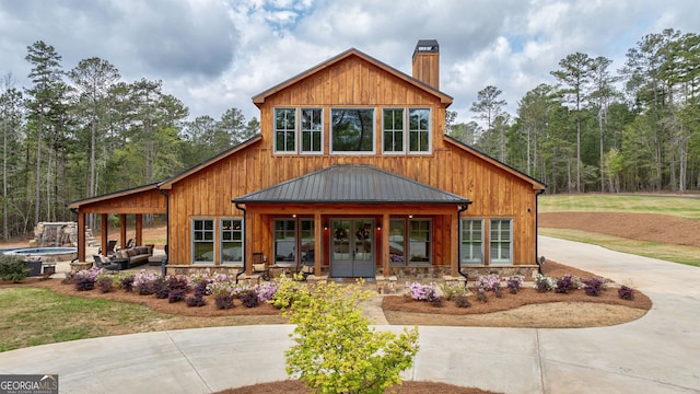 view of front of house featuring outdoor lounge area and french doors