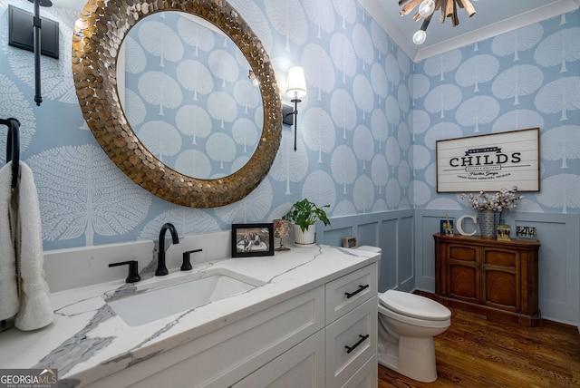 bathroom featuring vanity, crown molding, toilet, wood-type flooring, and a chandelier
