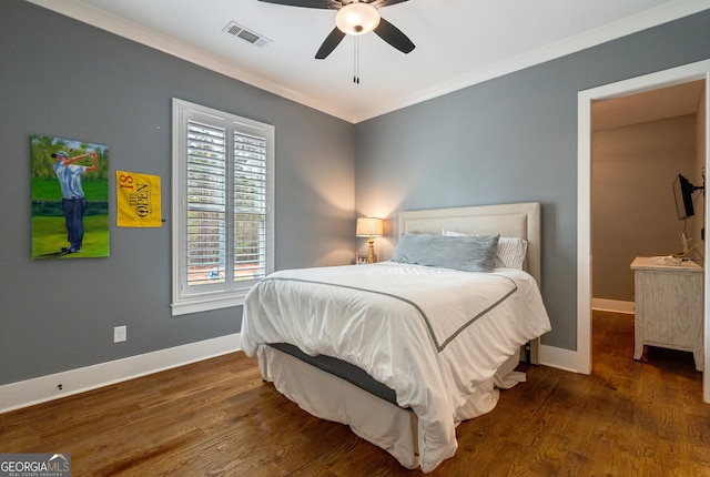 bedroom featuring ceiling fan, ornamental molding, and dark wood-type flooring