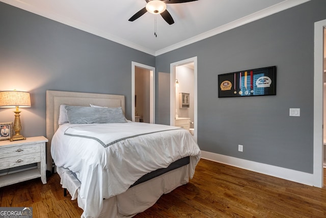 bedroom featuring connected bathroom, dark wood-type flooring, ceiling fan, and crown molding