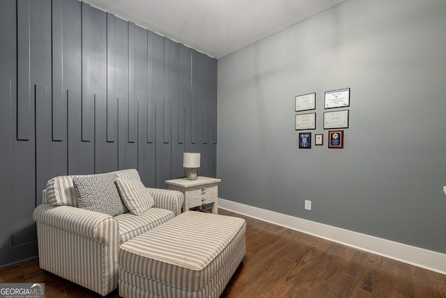 sitting room with dark wood-type flooring