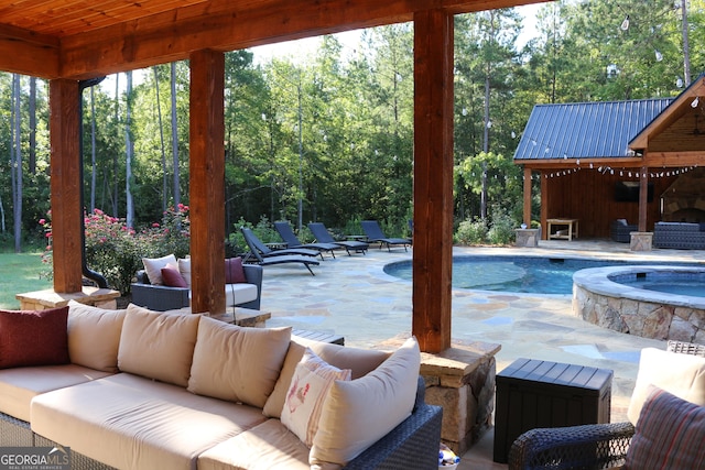 view of pool featuring outdoor lounge area, a patio area, and an in ground hot tub