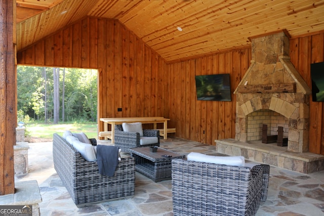 view of patio featuring an outdoor stone fireplace