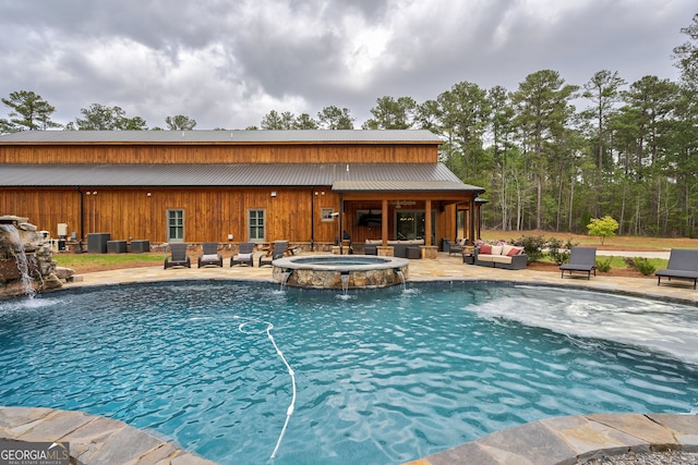 view of pool with pool water feature, an outdoor hangout area, an in ground hot tub, and a patio