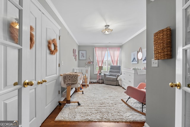 sitting room with ornamental molding and dark hardwood / wood-style flooring