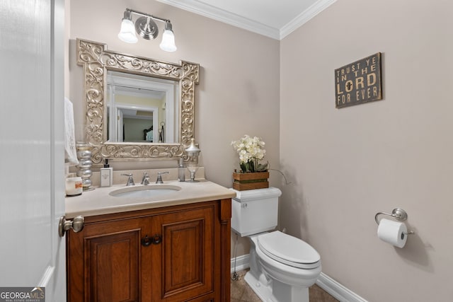 bathroom featuring toilet, vanity, and crown molding