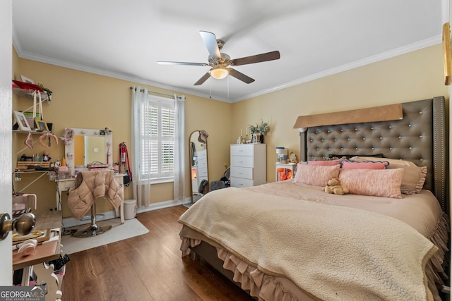 bedroom with ceiling fan, ornamental molding, and hardwood / wood-style flooring