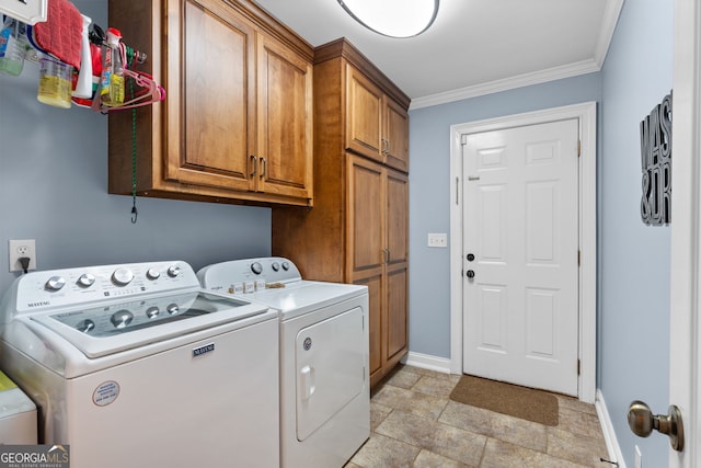 clothes washing area with crown molding, separate washer and dryer, and cabinets