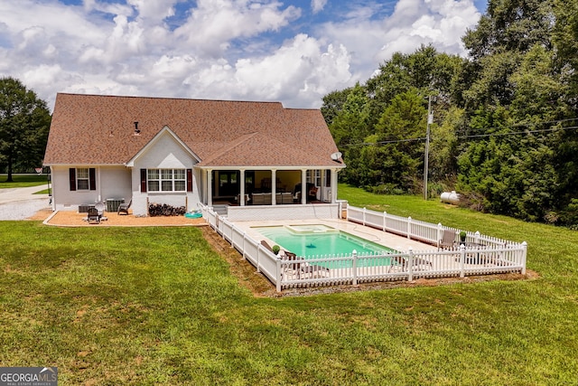 back of property with a sunroom, a patio area, a fenced in pool, a yard, and central air condition unit