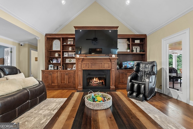 living room with vaulted ceiling, crown molding, and wood-type flooring