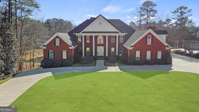 neoclassical home with a front yard