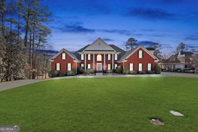 neoclassical home featuring a lawn