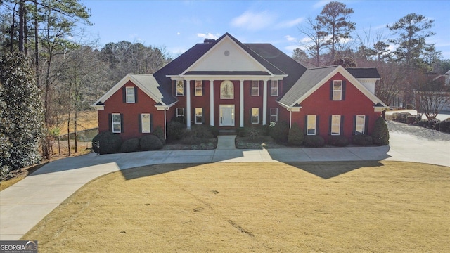 neoclassical home with a front yard