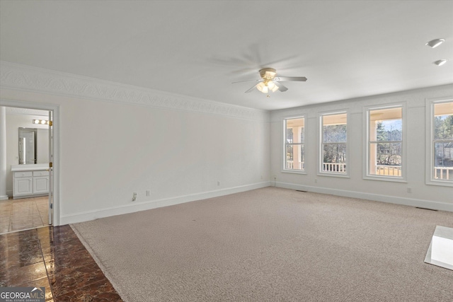 spare room with carpet floors and ceiling fan