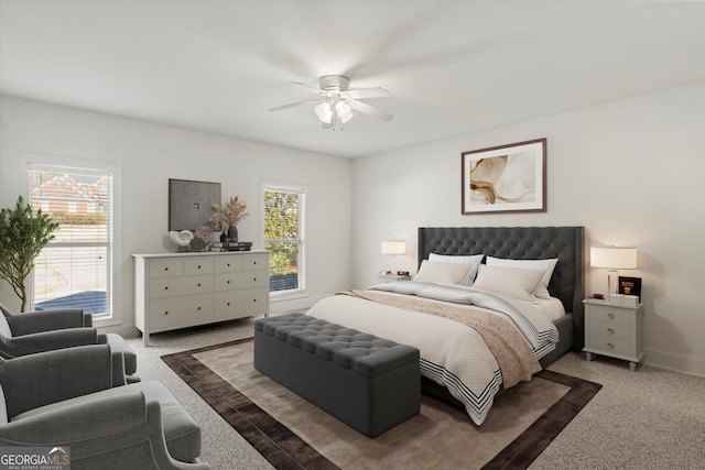 carpeted bedroom featuring ceiling fan and multiple windows