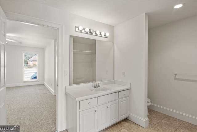 bathroom featuring tile patterned floors, vanity, and toilet