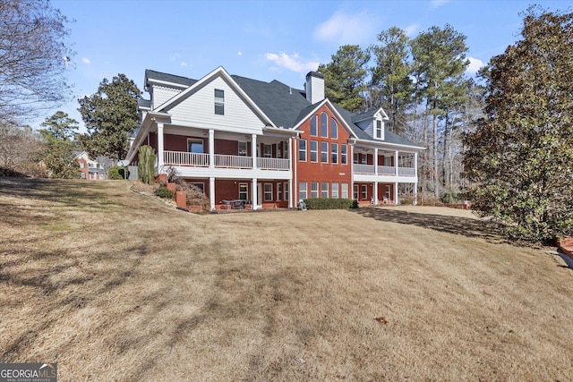 rear view of property featuring a yard