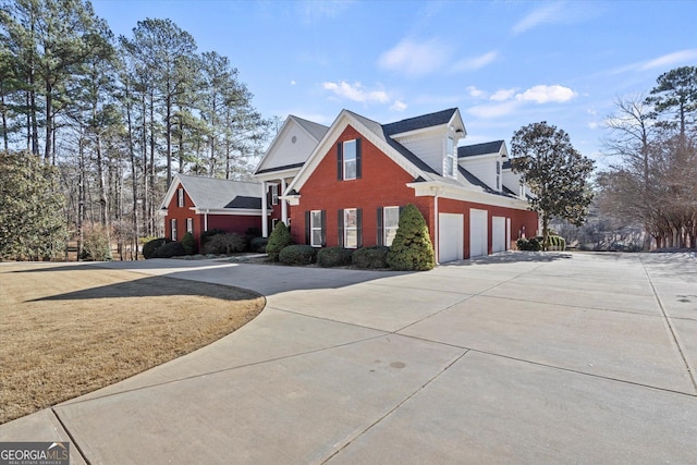 view of home's exterior with a yard and a garage