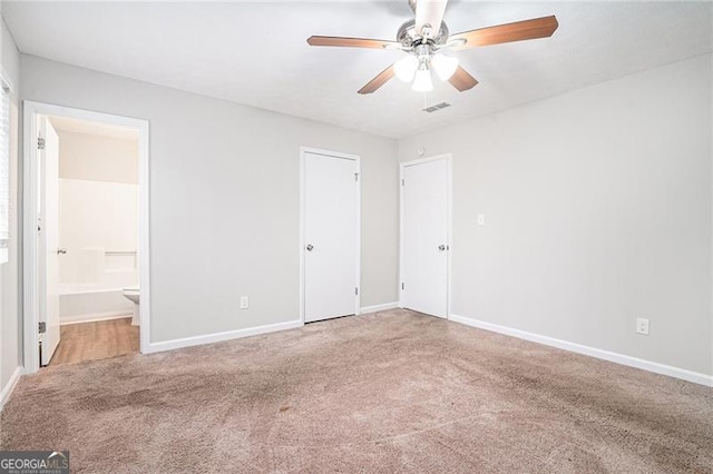 unfurnished bedroom featuring connected bathroom, ceiling fan, and carpet floors