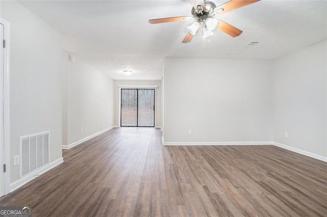 unfurnished room with ceiling fan and dark wood-type flooring