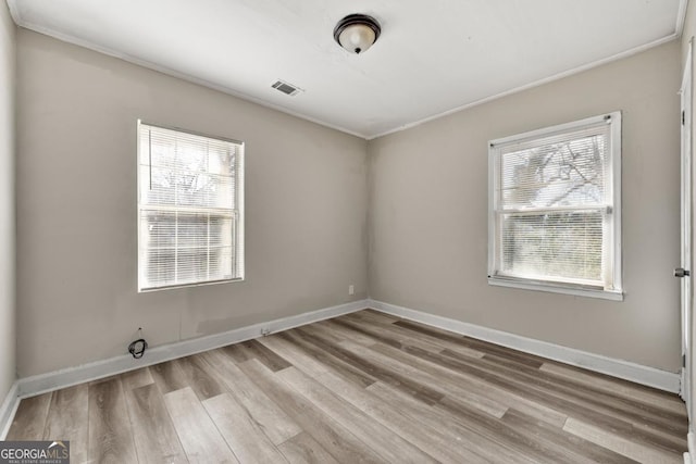 unfurnished room featuring light hardwood / wood-style flooring and crown molding