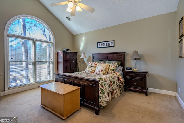 bedroom with light colored carpet, vaulted ceiling, and ceiling fan