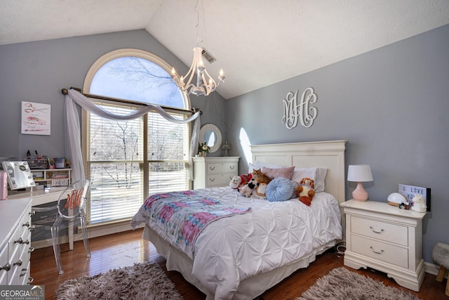 bedroom featuring dark wood-type flooring, lofted ceiling, and a notable chandelier