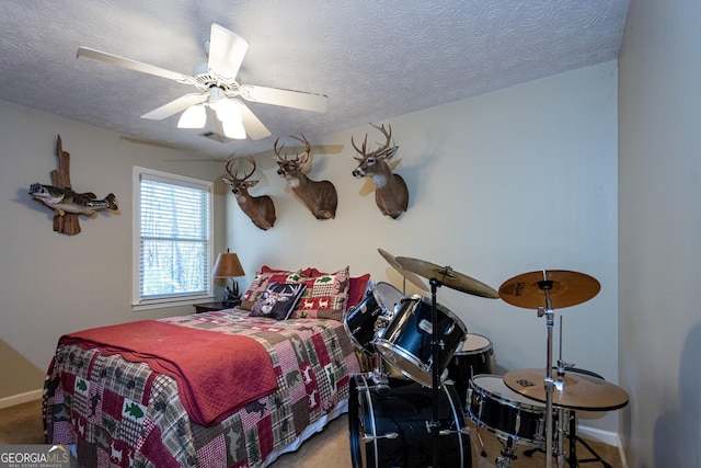 carpeted bedroom with ceiling fan and a textured ceiling