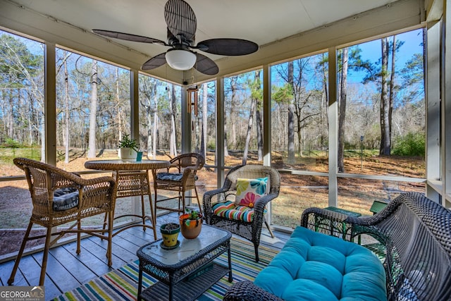 sunroom / solarium with ceiling fan and a healthy amount of sunlight