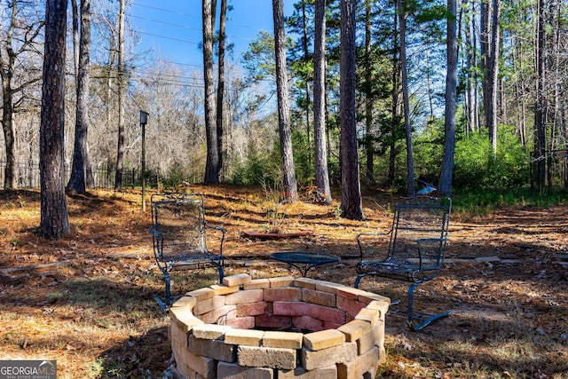 view of yard featuring an outdoor fire pit