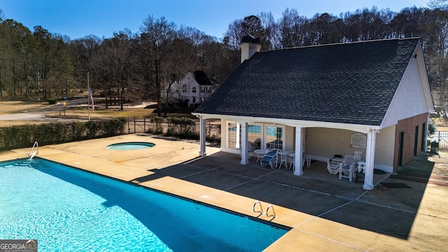 view of pool featuring an in ground hot tub and a patio