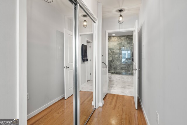 corridor featuring a barn door and hardwood / wood-style flooring