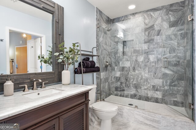 bathroom featuring tasteful backsplash, toilet, vanity, and walk in shower