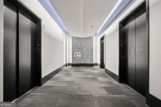 corridor featuring carpet flooring and elevator