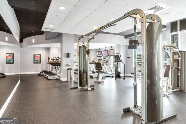 gym with a paneled ceiling