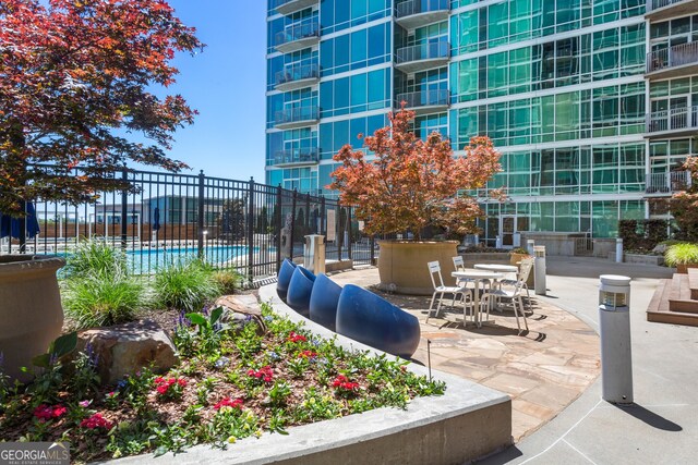 view of home's community featuring a patio and a pool