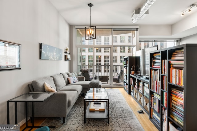 living room with wood-type flooring and a notable chandelier