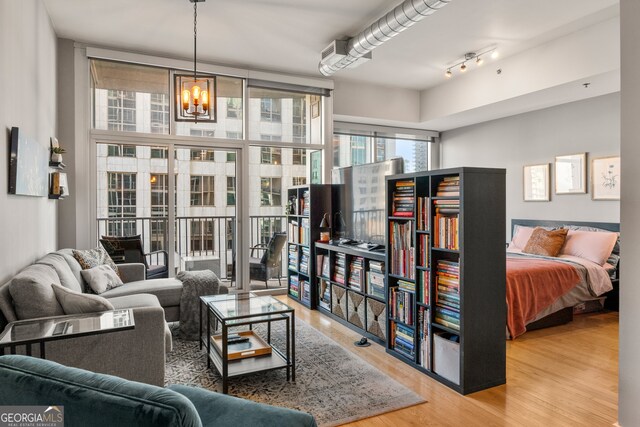 living room featuring a chandelier and wood-type flooring