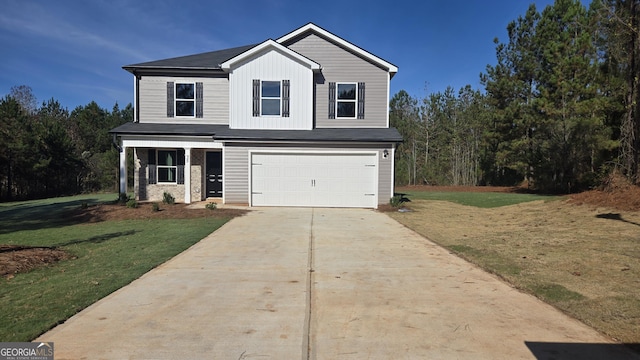 view of front of home with a front yard and a garage