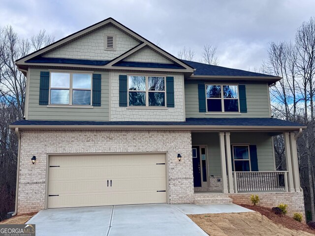 craftsman-style home with covered porch and a garage