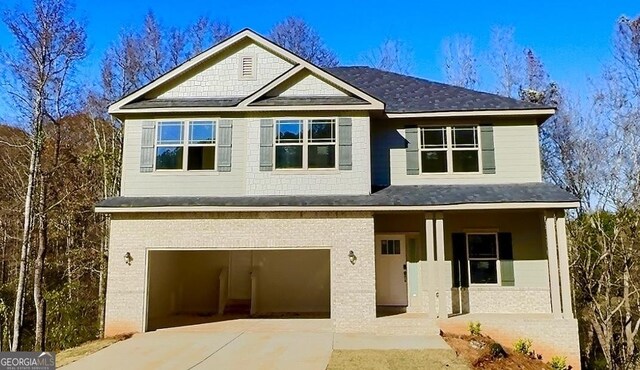 view of front of house with central AC and a garage