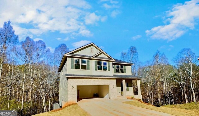 view of front of house with a garage and a front yard