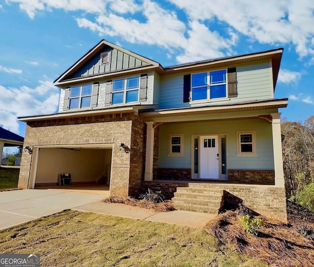 craftsman inspired home featuring a porch and a garage