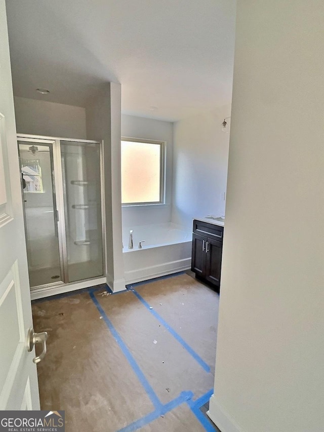 bathroom with vanity and separate shower and tub