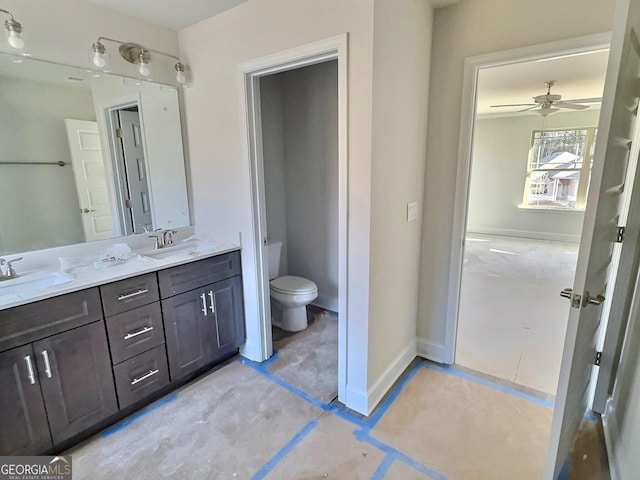 bathroom with ceiling fan, vanity, and toilet