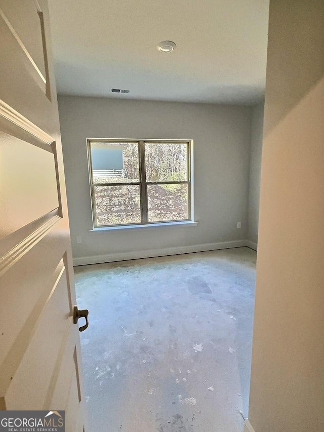 spare room with concrete flooring