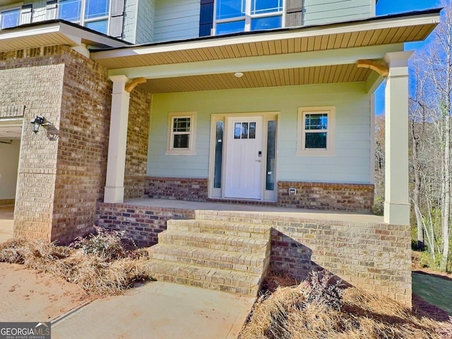 doorway to property featuring a porch