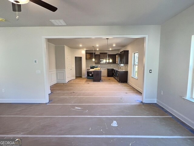 interior space with ceiling fan and sink