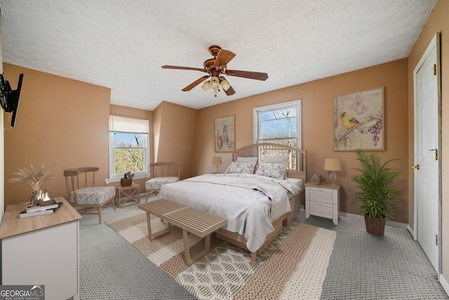 bedroom featuring ceiling fan and a textured ceiling